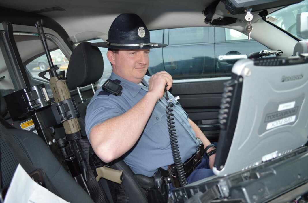 BBB.OSP.BRYAN FITCH GUNS INSIDE THE COCKPIT of an Oregon State Police cruiser, Senior Trooper Bryan Fitch (ret.) is surrounded by high-tech equipment, including a computer, and high-powered weapons, including an AR-15-style rifle. (Beacon file photo)
